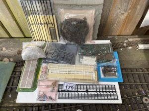 Job lot  Box of scenery items - bag of boulders, Peco stone platform edging, Peco gates & stiles, Peco lineside kits 1 & 2, Peco flexible field fencing, Ratio gutters & downpipes, loose fencing strips, Langley white metal farm figures, chickens & seated drivers.